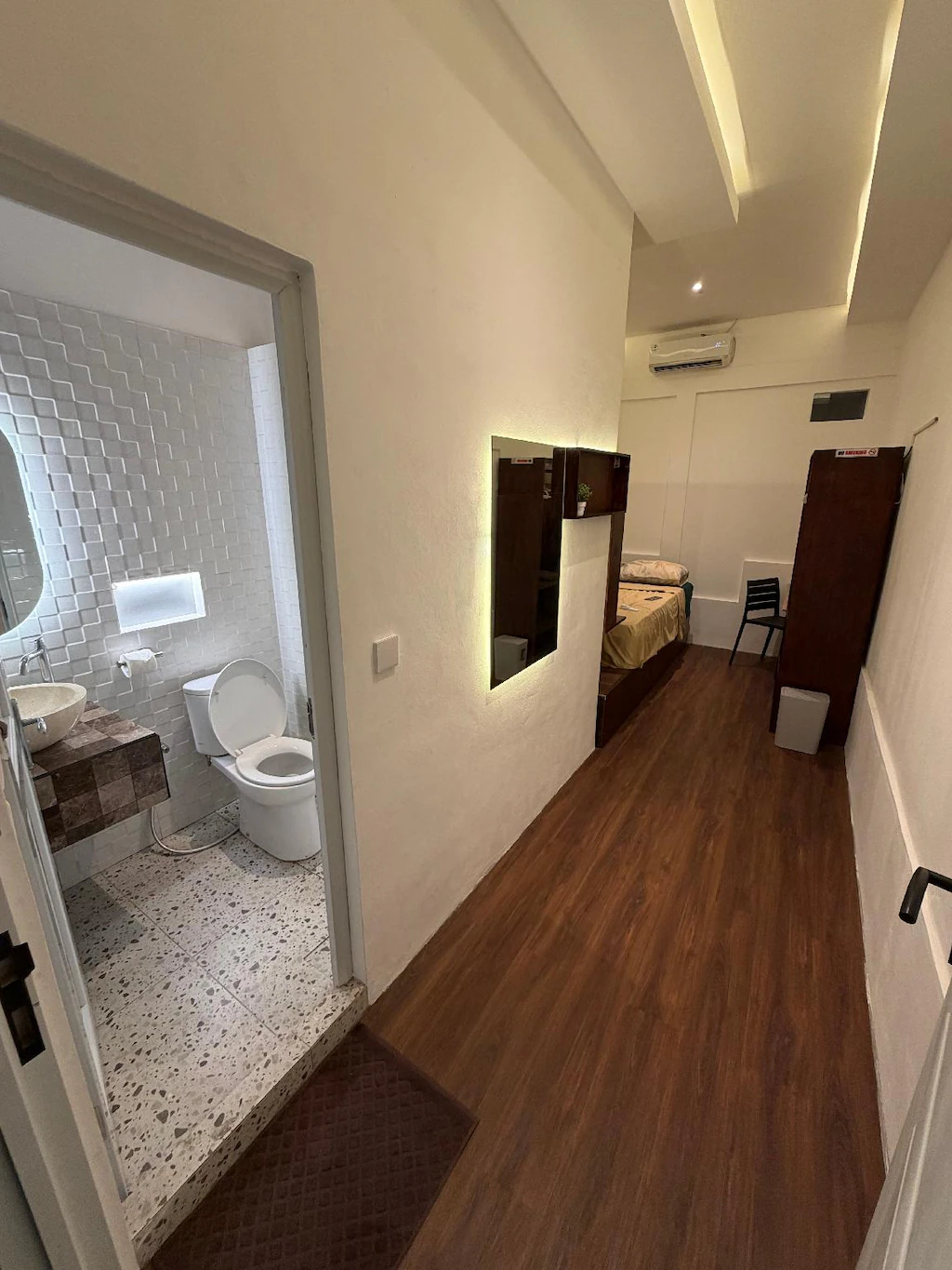 bedroom angle with bathroom viewable
