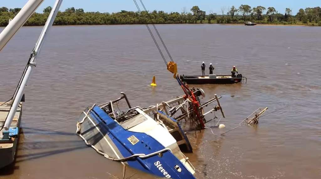 Inside the Burnett River flood clean-up as boats, pontoons and debris are recovered