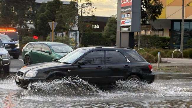 Flooding outside Gateway Plaza forces motorists through deep water in Leopold - Geelong, VIC