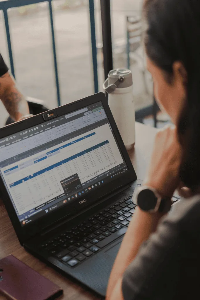Woman reads spreadsheets on laptop