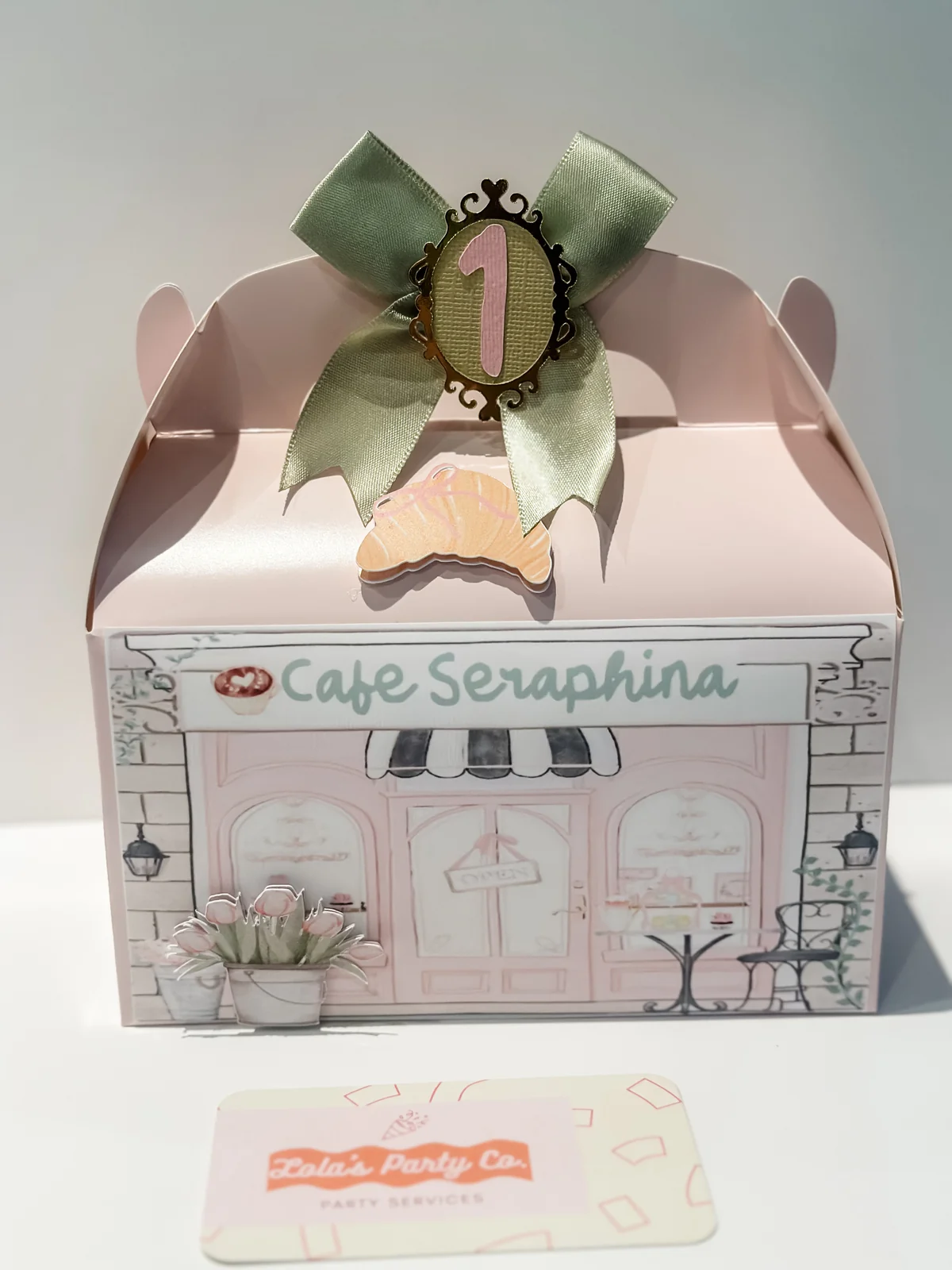 Custom pink party favor gift box with sage bow and Lola's Party Co. branding card