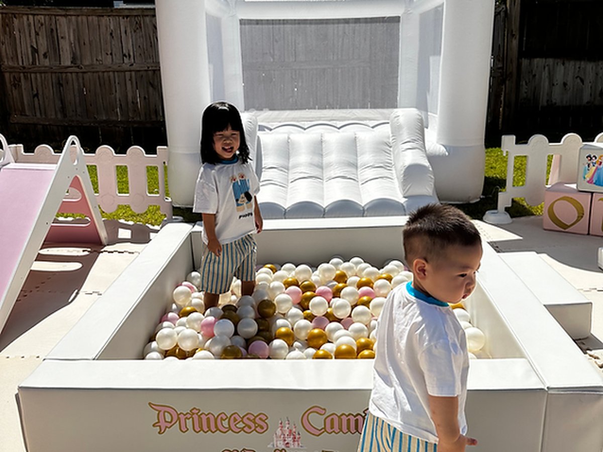 Outdoor soft play setup with bounce house and ball pit