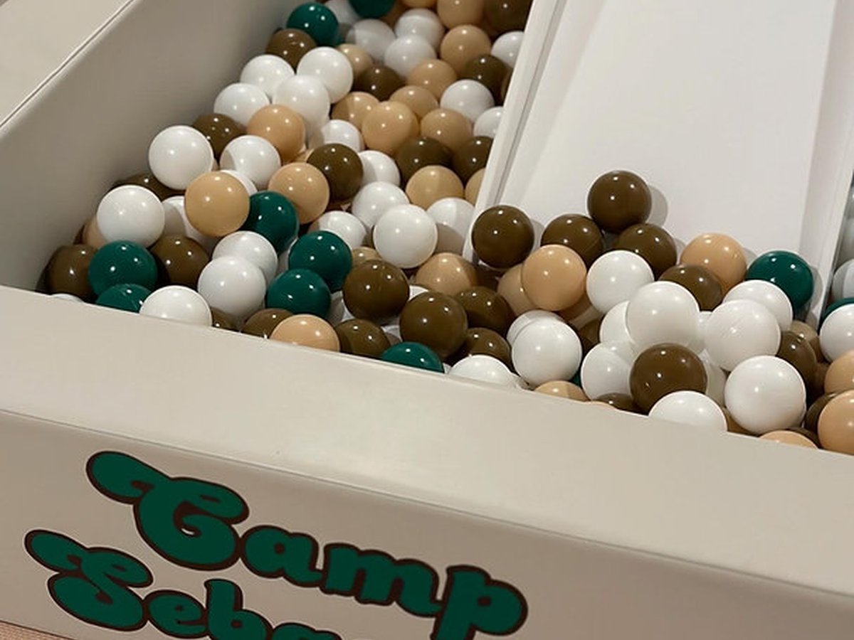 Camp-themed ball pit with earthy tones