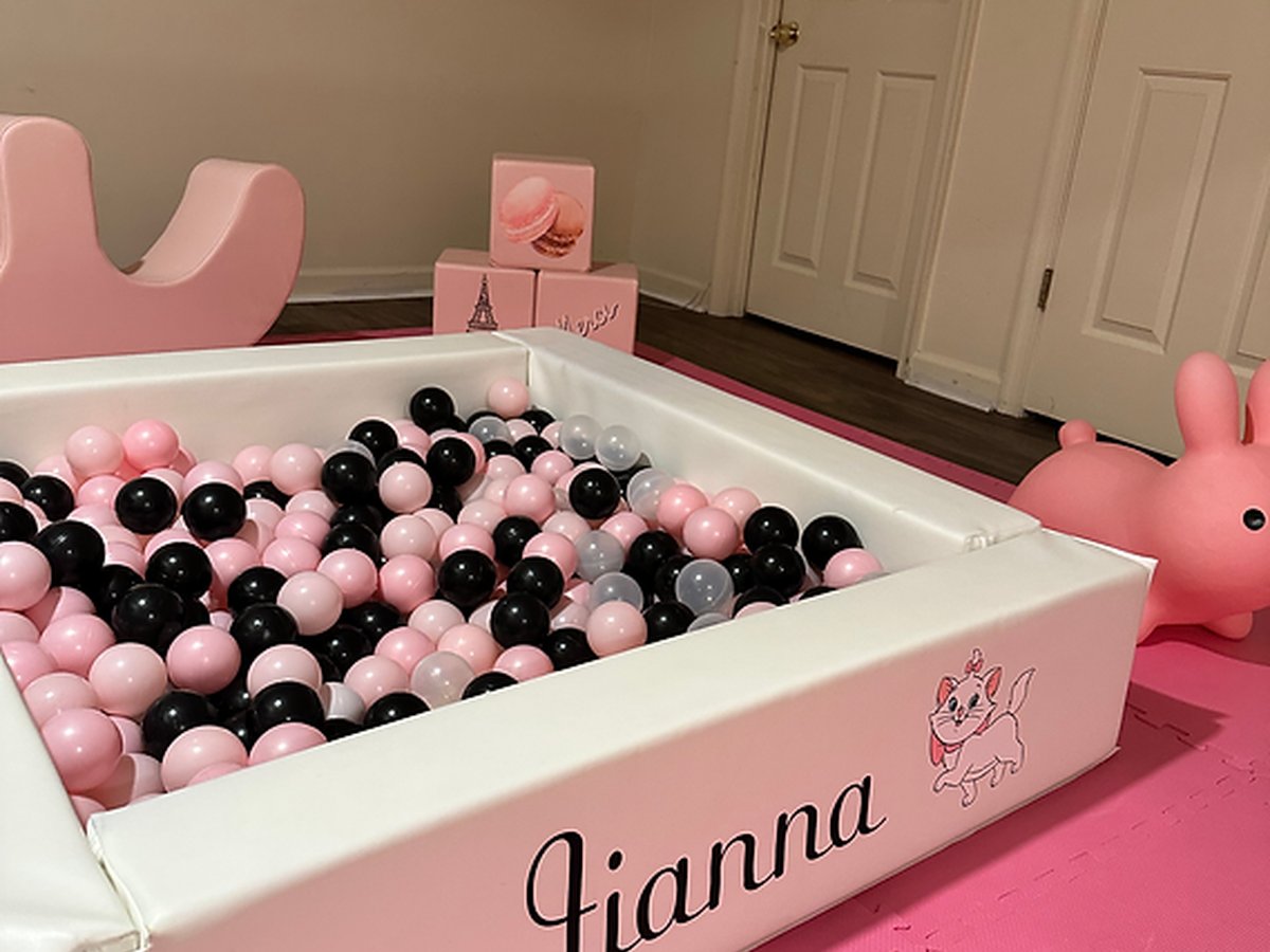 Pink ball pit setup for indoor party
