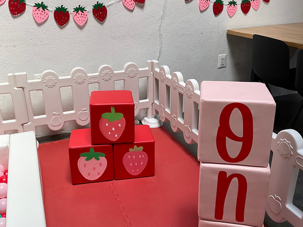 Strawberry-themed table setup with party blocks