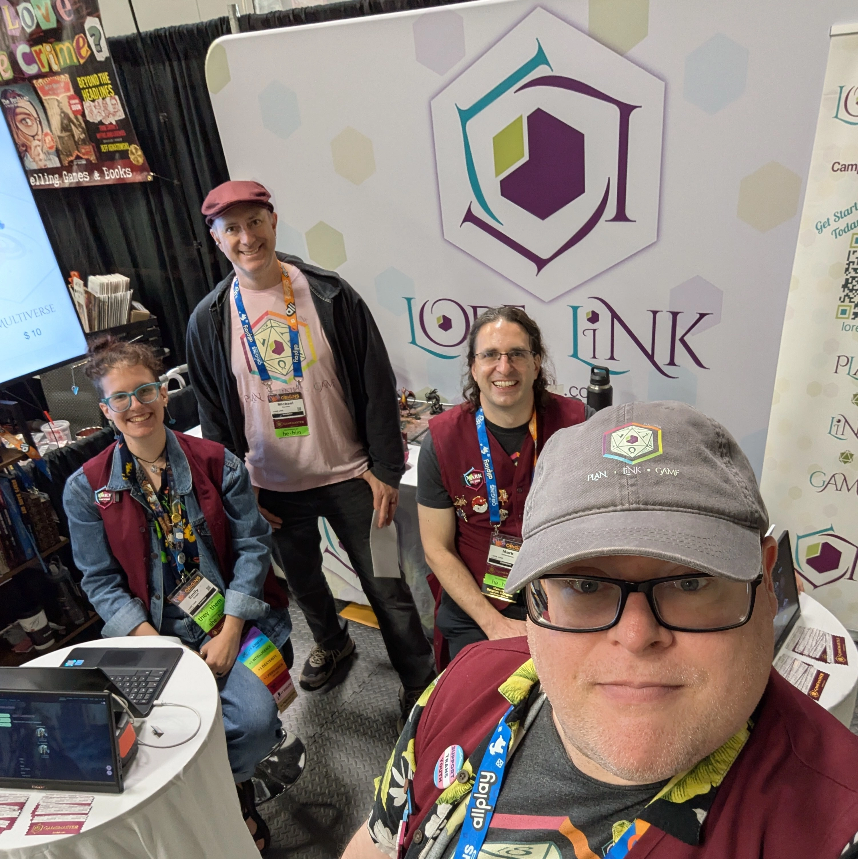 A selfie showing all four members of the team that attended Origins. Three are smiling, while the person holding the camera looks focused.