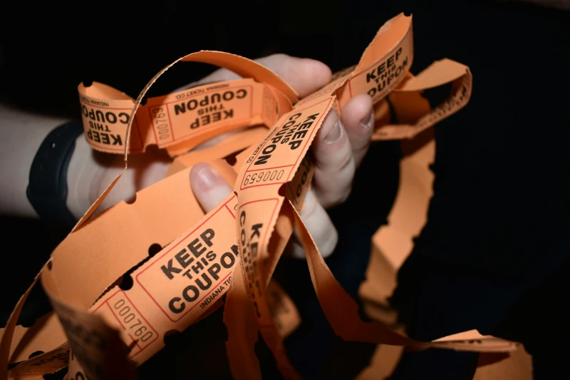 Orange raffle tickets on a black background