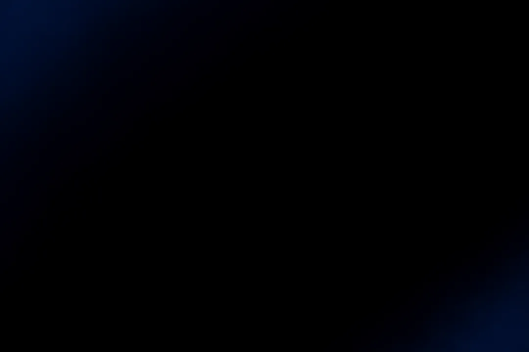 A black panel with only a faint dark blue tint at the edges, no shapes visible.