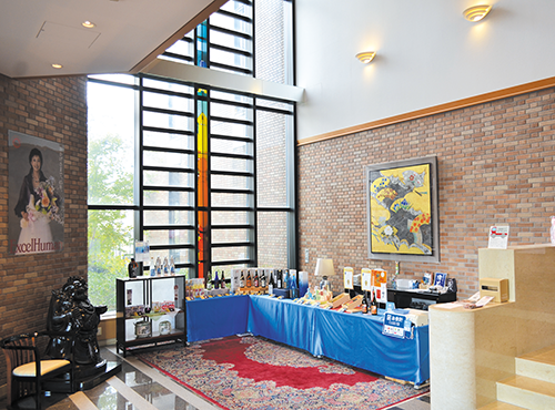 Bright entrance hall with stained-glass window and tasting display at the brewery.