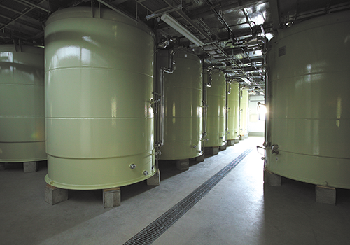 Rows of large storage tanks in the brewery.