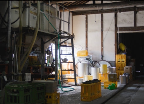 Interior of the brewing hall showing fermentation tanks and equipment.