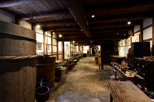 Interior of the exhibition storehouse, lined with historic brewing tools and displays.