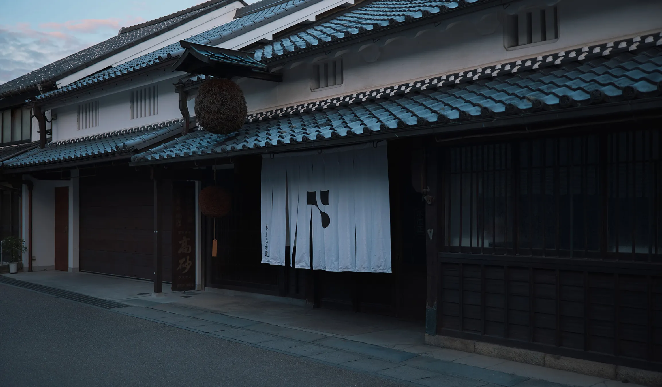 Evening view of the brewery's registered tangible cultural property storefront on the old post-road street.