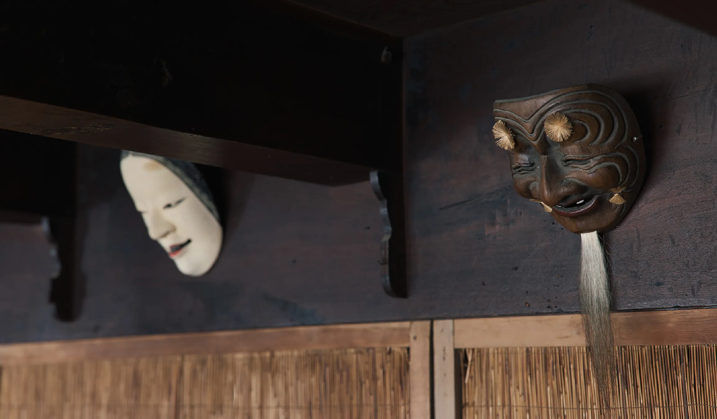 Traditional Noh masks displayed inside the historic building, reflecting the local Noh theater heritage of Nabari.