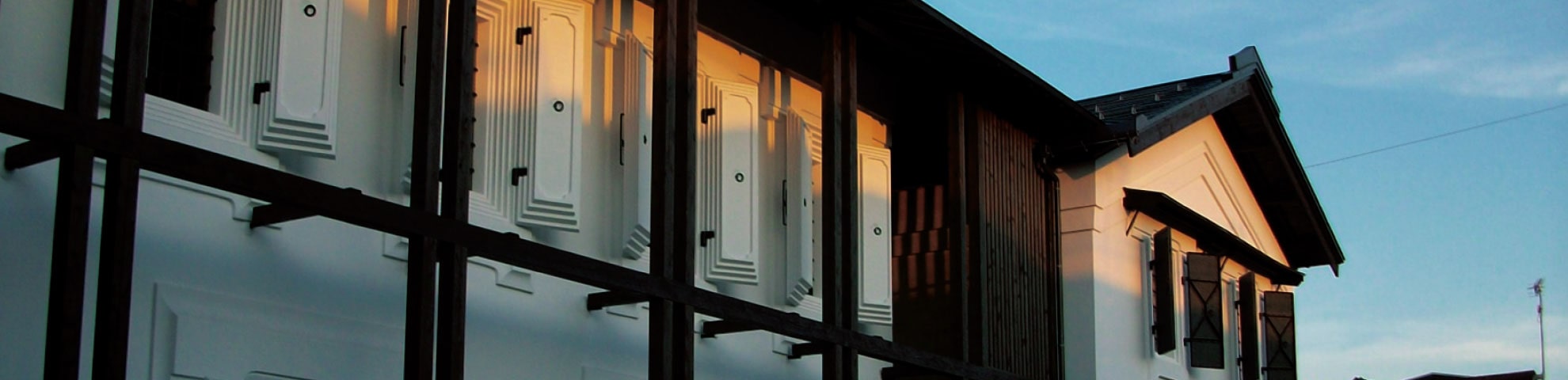 Exterior of the registered heritage storehouse buildings at dusk.