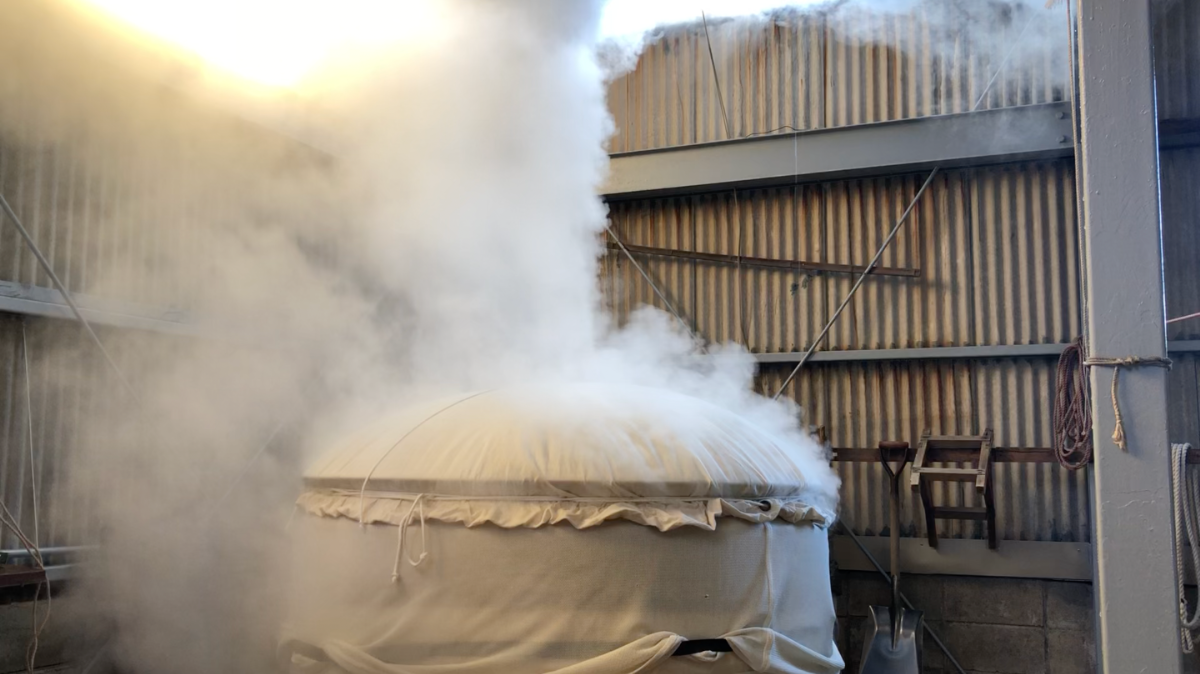 A koshiki steamer venting steam inside the brewery building.