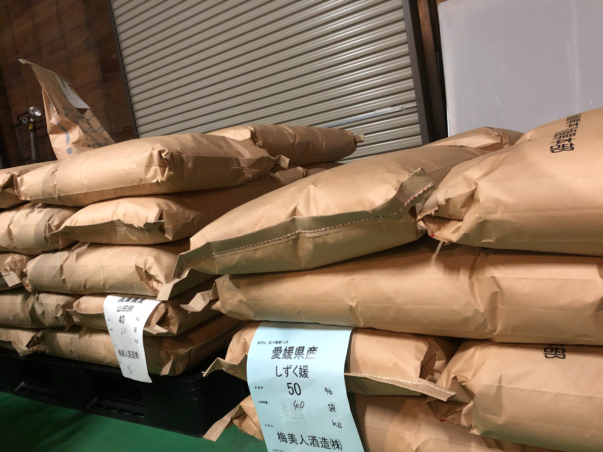 Sacks of rice, including Yamada Nishiki and Shizuku Hime, stored at the brewery.