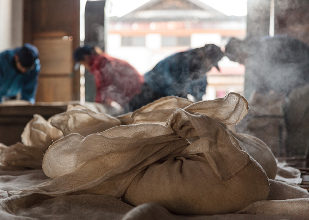 Steaming moromi mash bags during the brewing process.