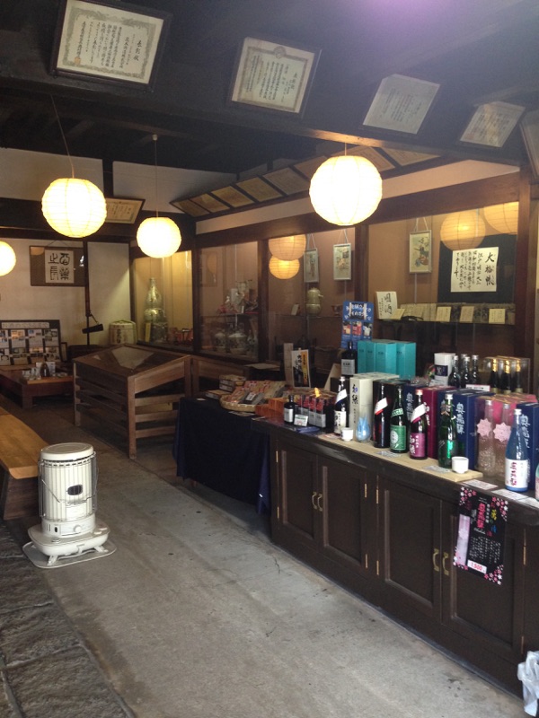 Interior showroom with paper lanterns and awards on display.