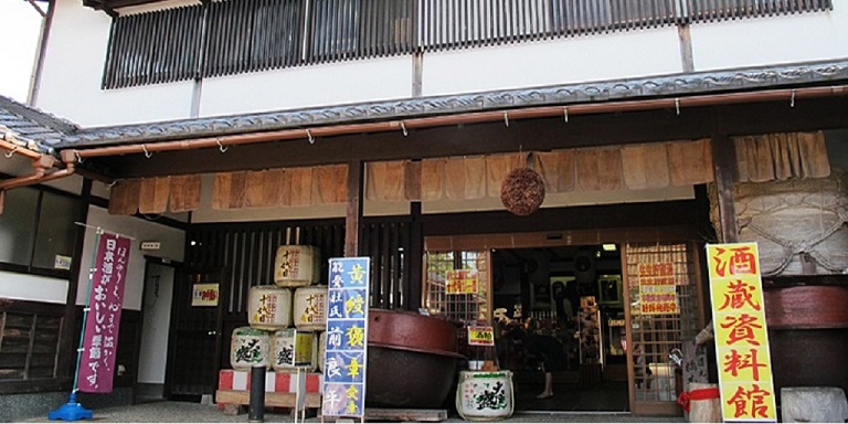 Traditional building exterior with sake museum entrance signage