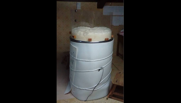 Moromi (fermenting mash) rising in an open fermentation tank.