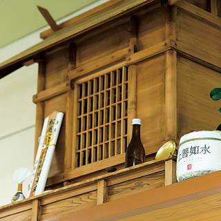 Traditional wooden interior display shelf with sake bottles
