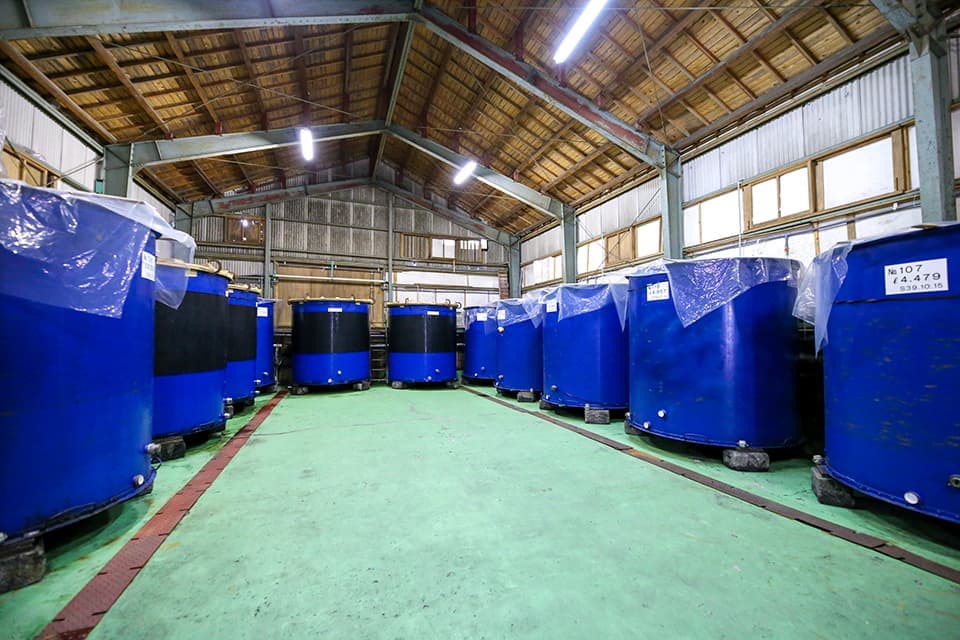 Interior of the brewery storehouse lined with large fermentation tanks.