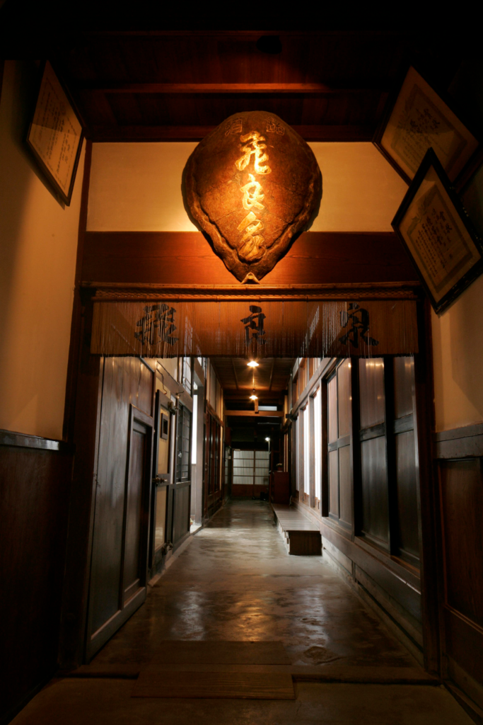 Wood-paneled entrance corridor inside the historic brewery building, lined with commendation plaques.