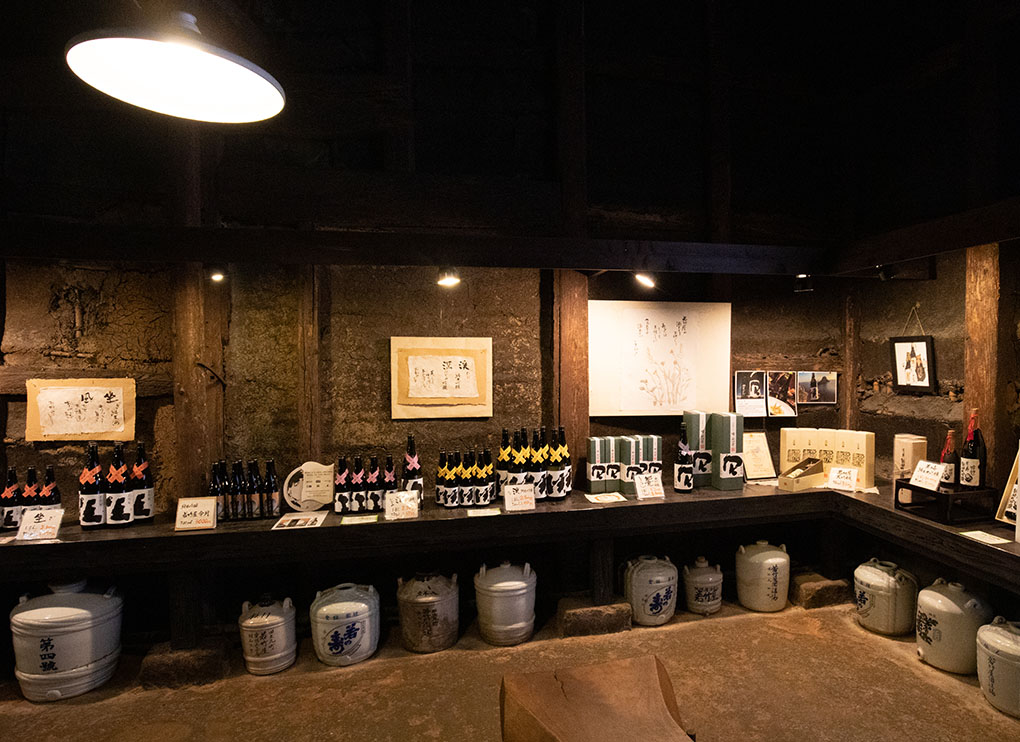 Historic sake bottles, jugs and awards on display inside the Genroku-gura.