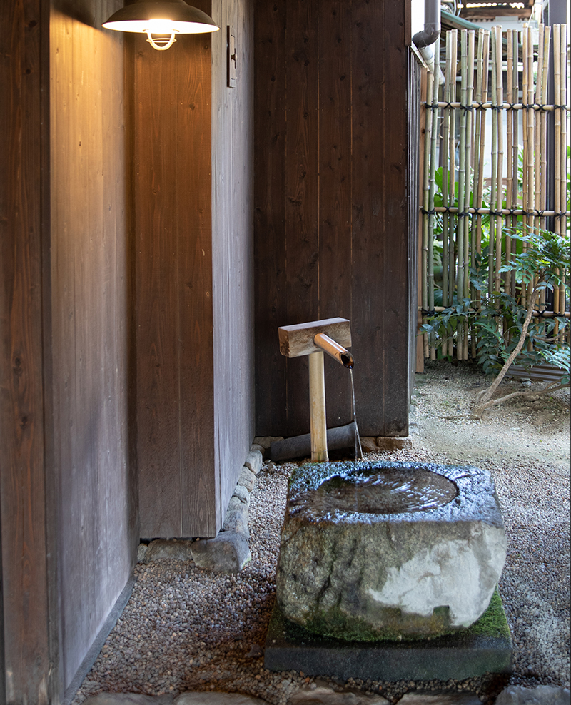 Stone water basin (tsukubai) fed by the brewery's well water.