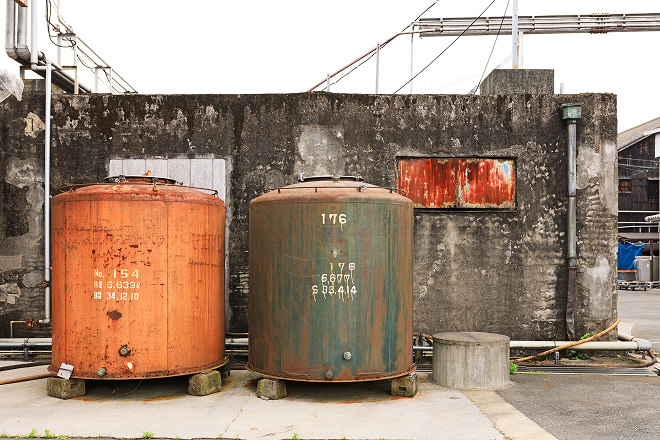Weathered storage tanks used in the brewing process.