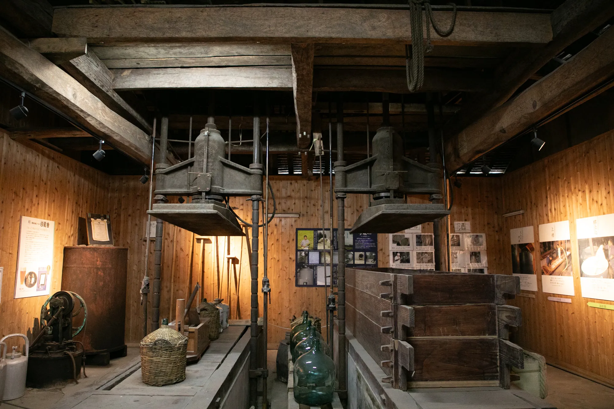 Historic sake press (fune) and brewing tools preserved in the brewery's history museum room