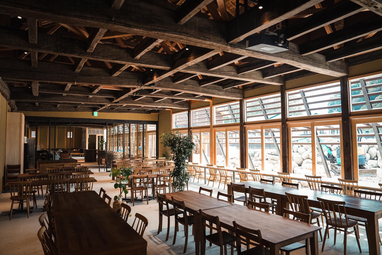 Interior of the renovated brewery hall with exposed wooden beams, now used as the Suginoya Garten dining space