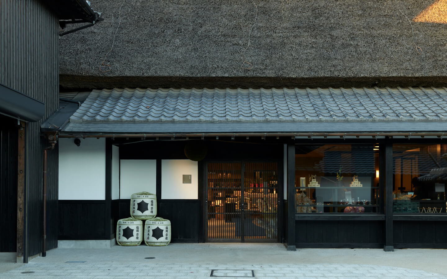 Brewery shopfront entrance with stacked sake barrels