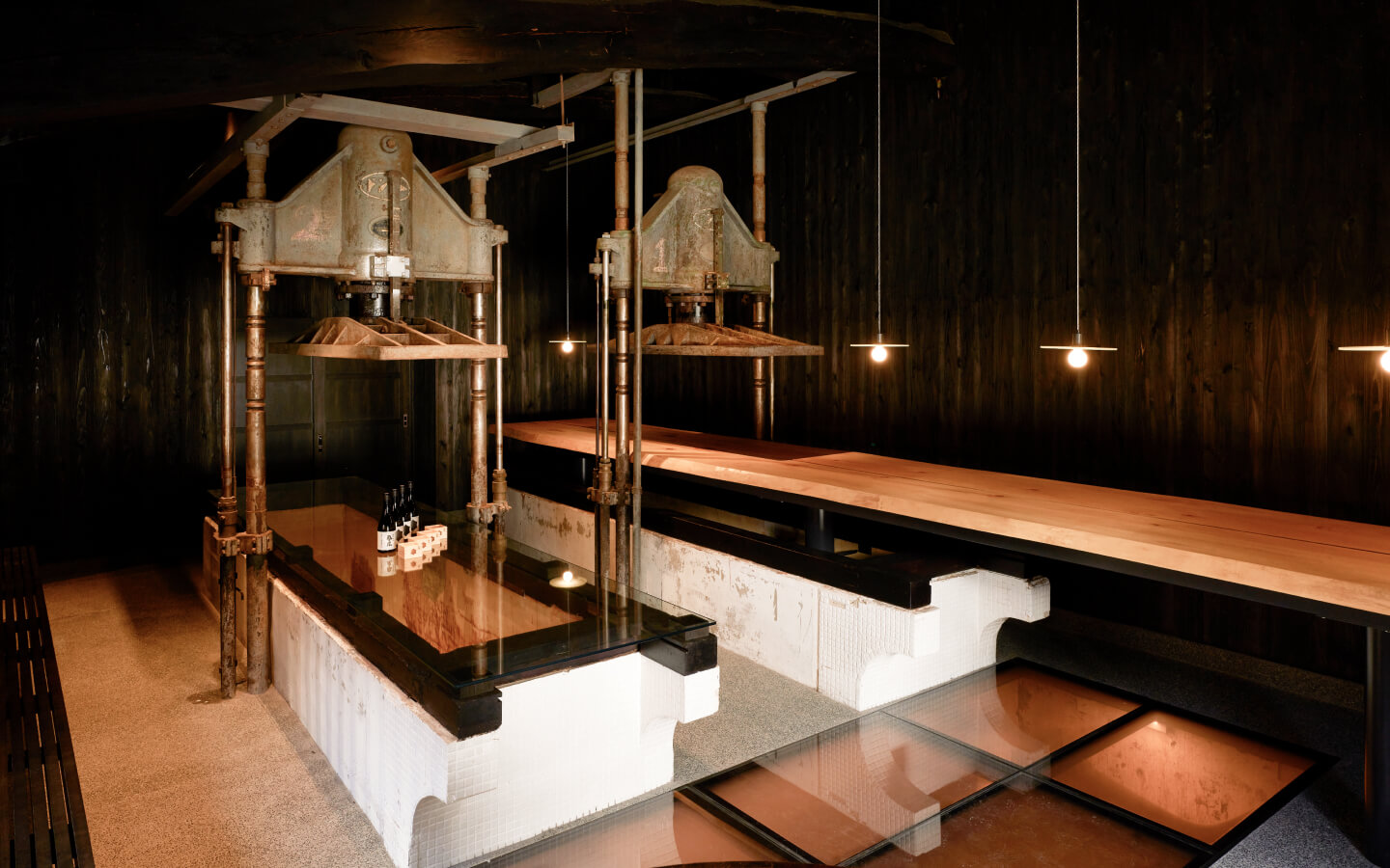 Sake bar counter repurposed from the brewery's traditional fune-shibori press equipment