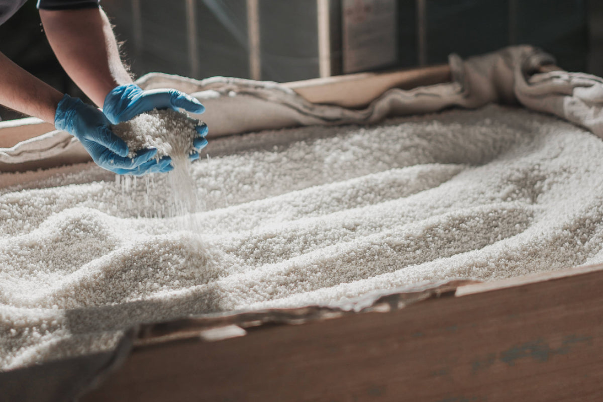 Steamed rice being handled during the koji-making process.