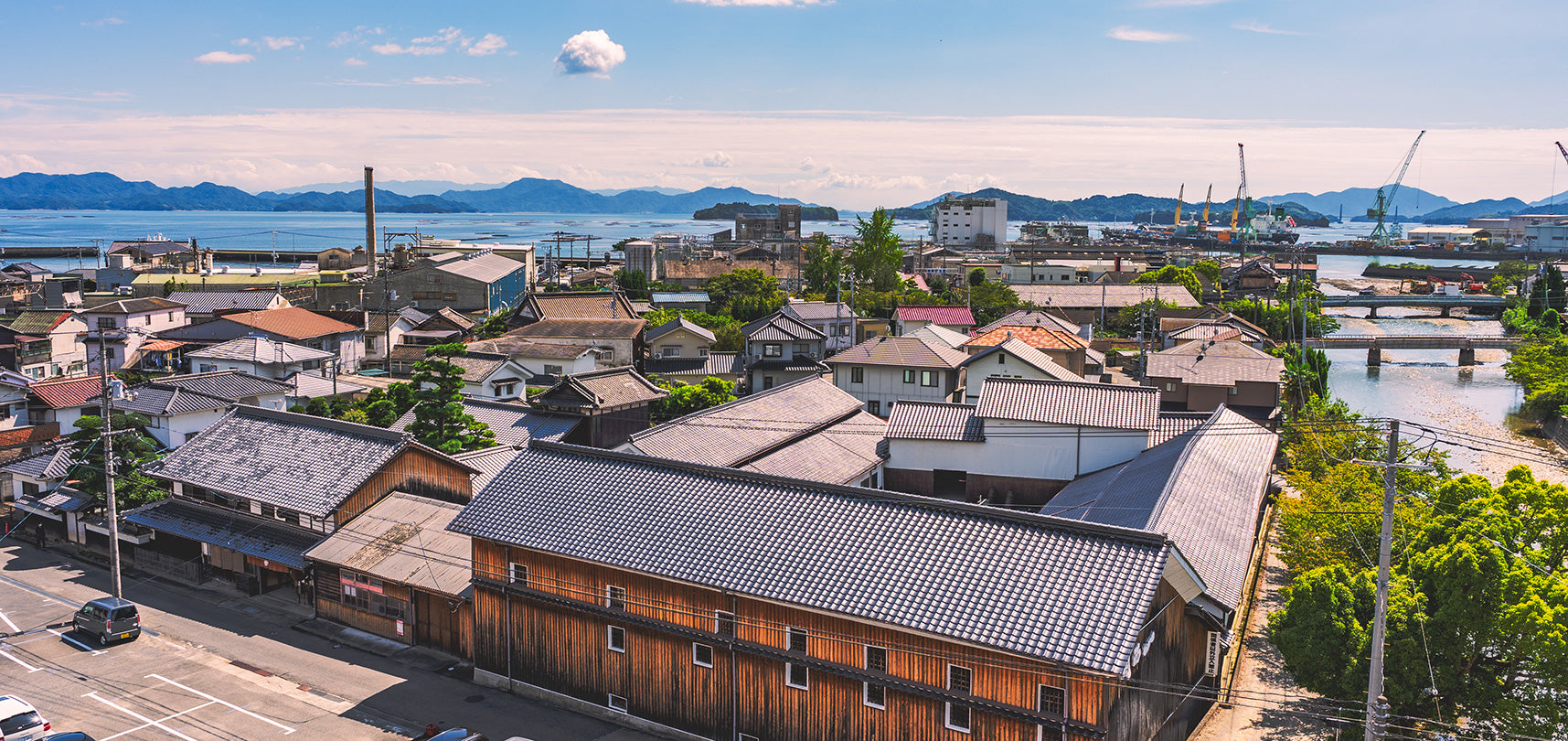 Aerial view of the brewery's kura warehouses within the port town of Akitsu