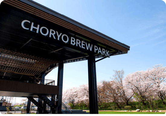 Choryo Brew Park exterior with cherry blossoms in bloom