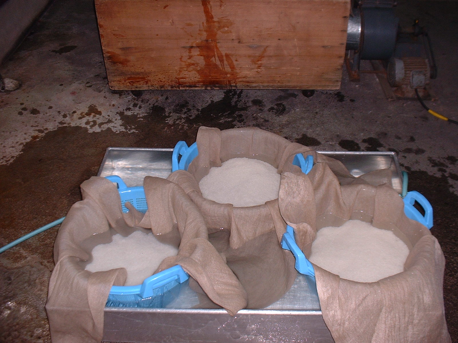 Rice soaking in cloth baskets before steaming