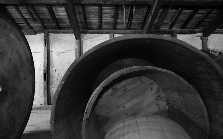 Traditional wooden fermentation tubs inside the brewery.