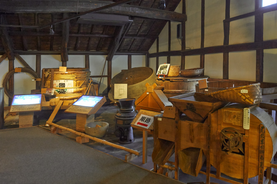 Traditional sake-brewing tools and equipment on display inside the Sakenobunkakan museum.