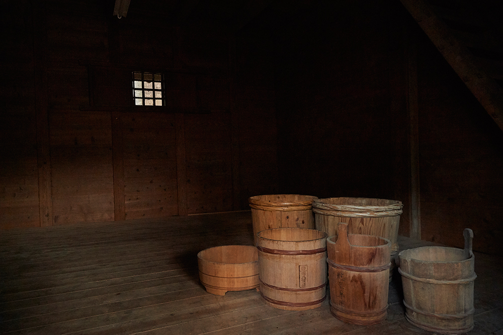 Traditional wooden tubs stored in the loft of the old kura