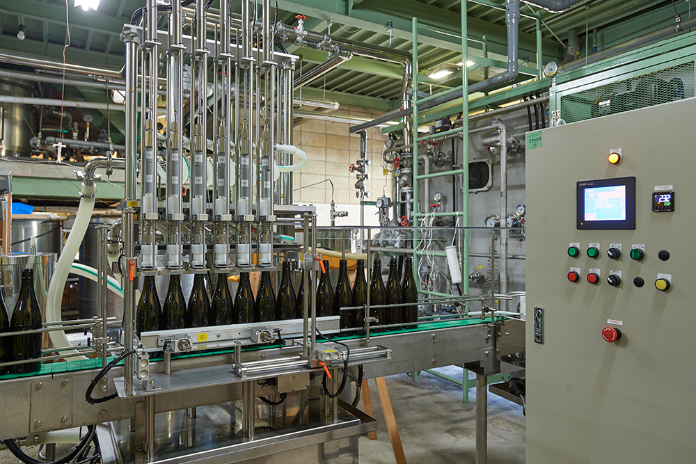 Automated bottling line filling sake bottles at the modern brewery