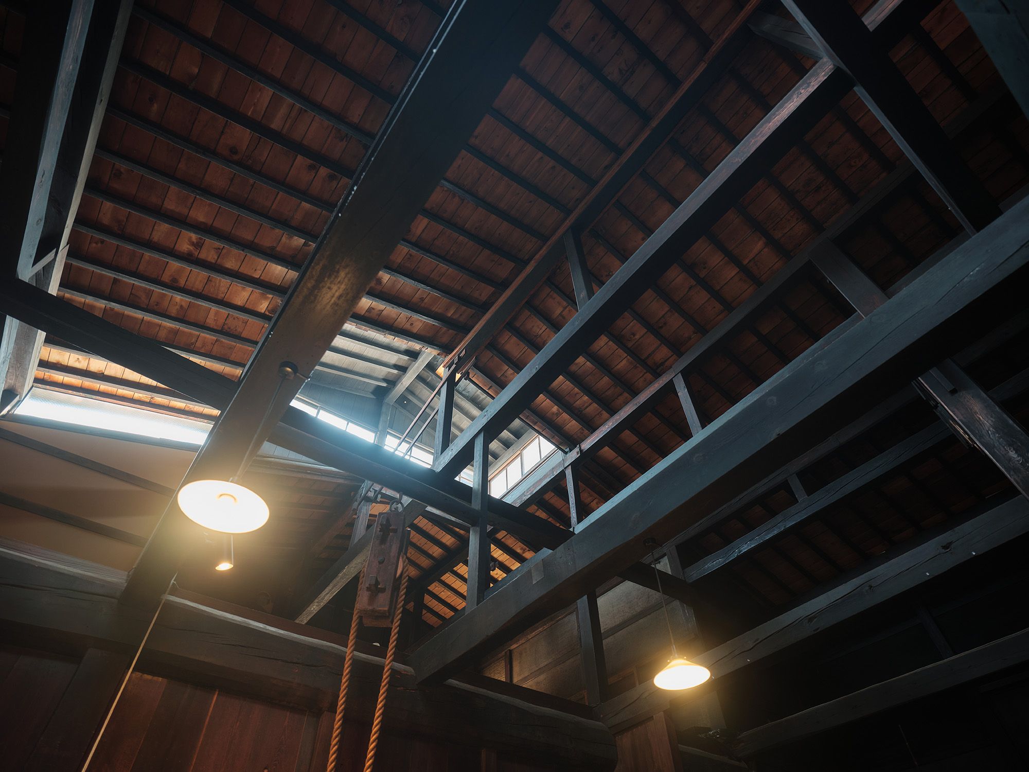 The exposed wooden roof beams above the brewery's traditional double-height earthen-floored hall.