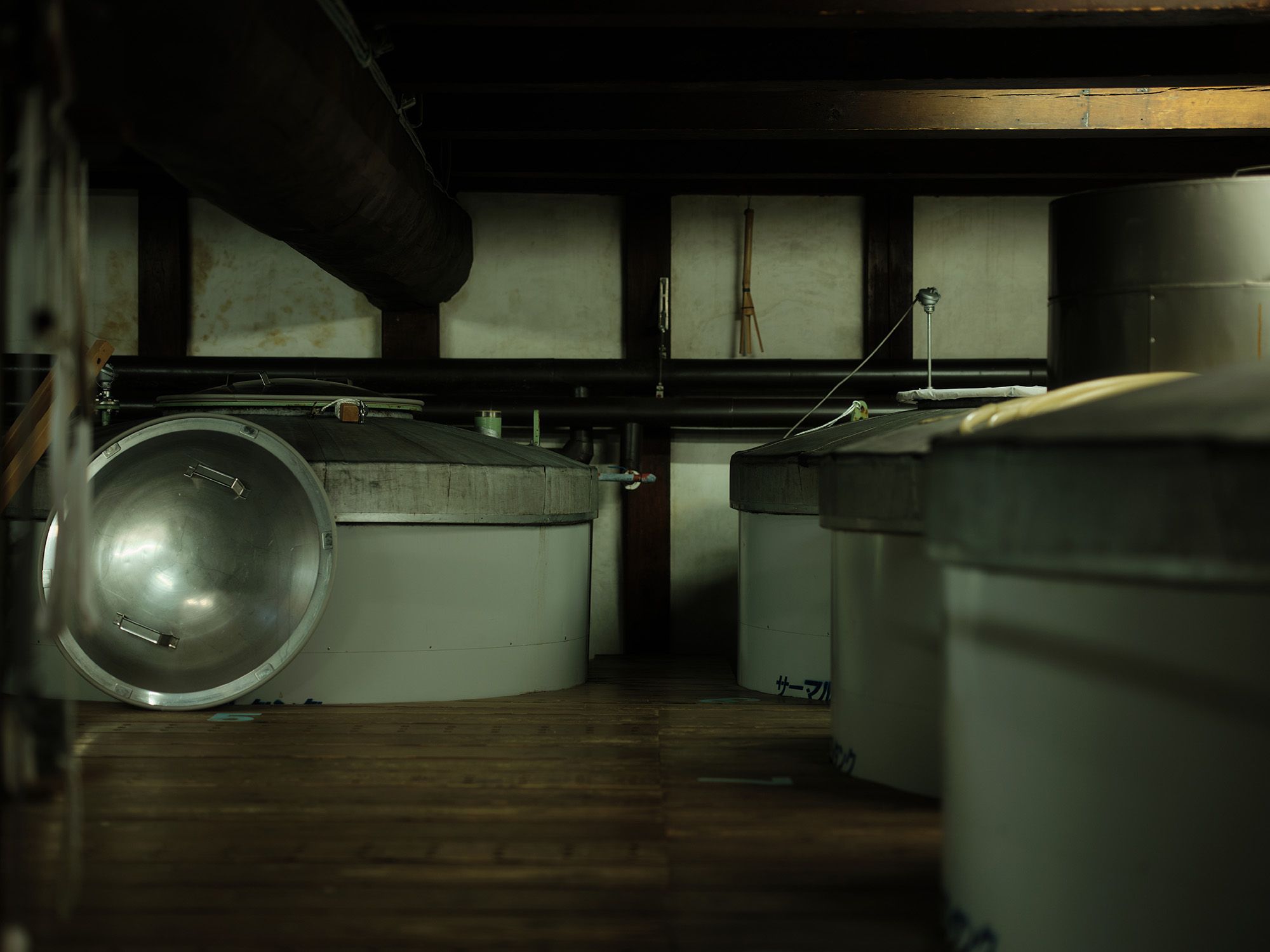Fermentation tanks lined up inside the brewery.
