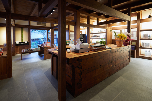 Interior of the shop showing exposed traditional wooden beam architecture and a wooden sales counter.