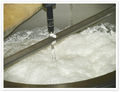 Fermenting moromi mash bubbling in a brewing tank