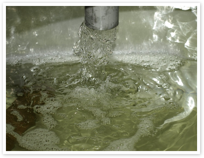Water being added into a fermentation tank during brewing