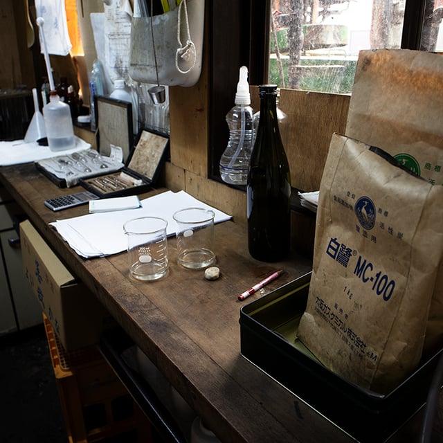 Analysis workbench with beakers and testing equipment used for sake quality control