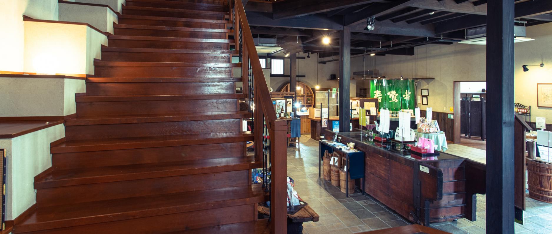 Interior of the Rokusai gallery shop, showing the wooden staircase and tasting counter.